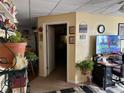 Cozy living room featuring beige walls, a doorway, and a TV over a desk at 2195 Wilson Rd, Conyers, GA 30012