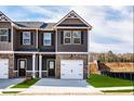 Newly constructed townhome with a private entrance, attached garage, and front yard landscaping at 235 Ivey Ter, Temple, GA 30179