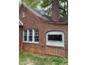 Home exterior highlighting brick facade, windows, and a satellite dish, blending functionality with classic design at 240 Mathewson Sw, Atlanta, GA 30314