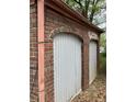 Exterior wall with rustic brickwork and arched garage doors, adding character to the property's facade at 240 Mathewson Sw, Atlanta, GA 30314