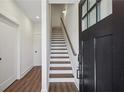 Bright entryway featuring hardwood floors, staircase and natural light from the front door window at 103 Mission Se Way # 103, Atlanta, GA 30315