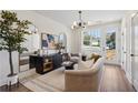 Inviting living room with modern lighting, neutral decor, and a door leading to a deck at 103 Mission Se Way # 103, Atlanta, GA 30315
