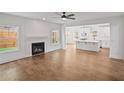 Bright living room featuring hardwood floors, a fireplace, and an open-concept view of the kitchen at 2438 Whites Rdg, Decatur, GA 30034