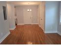 Open dining room features hardwood floors, neutral walls, and a classic chandelier, ready for personal touches at 4075 Sw Fairburn Sw Ave, Atlanta, GA 30331