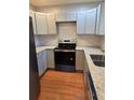 Modern kitchen featuring gray cabinets, granite countertops, stainless steel appliances and wood flooring at 4075 Sw Fairburn Sw Ave, Atlanta, GA 30331