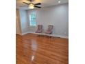 Cozy living room featuring hardwood floors, a ceiling fan, and stylish chairs by the window at 4075 Sw Fairburn Sw Ave, Atlanta, GA 30331