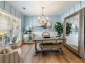 Elegant dining room featuring stylish decor, wood floors, a large mirror, and ample natural light at 6215 Barley Sq, Sugar Hill, GA 30518