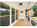 Inviting front porch with wood decking and views of the landscaped yard at 77 Township Drive, Hiram, GA 30141