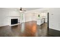 Open-concept living area with fireplace, hardwood floors, and adjacent kitchen at 77 Township Drive, Hiram, GA 30141