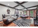 Spacious living room with wood beam ceiling, fireplace, and ample seating at 2030 Spring End Ct, Lawrenceville, GA 30044