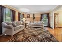 Cozy living room with hardwood floors, a patterned rug, and comfortable seating at 2030 Spring End Ct, Lawrenceville, GA 30044