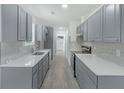 Modern kitchen with gray cabinets, subway tile backsplash, and stainless steel appliances at 9263 Club View Trce, Riverdale, GA 30274