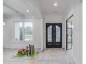 Elegant entryway features black framed glass doors and hardwood floors, adding modern style to the space at 3205 Bold Springs Rd, Dacula, GA 30019