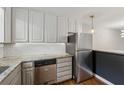 Well-lit kitchen features granite countertops, subway tile backsplash, and stainless steel appliances at 346 Carpenter Dr # 77, Sandy Springs, GA 30328