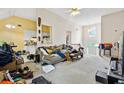 Bright living room featuring carpet, a ceiling fan, and access to the kitchen at 5181 Saint Claire Pl, Powder Springs, GA 30127