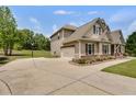 Spacious driveway leading to a beautiful home with an attached garage at 127 Grayson Myers Dr, Villa Rica, GA 30180