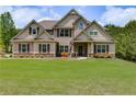 Charming traditional home with well-maintained lawn and landscaping at 127 Grayson Myers Dr, Villa Rica, GA 30180