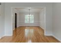 Bright dining room with hardwood floors, chair rail and ample space for entertaining at 3717 Lockerbie Ln, Powder Springs, GA 30127