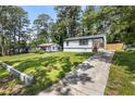 Charming home with fresh exterior, manicured lawn and long driveway at 4134 Burgess Dr, Decatur, GA 30035
