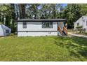 Beautiful home featuring manicured lawn, white siding, and black trim at 4134 Burgess Dr, Decatur, GA 30035