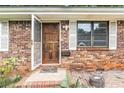 Close up of the front door with brick accents, welcome mat, and window at 2954 Ann Marie Ln, Rex, GA 30273