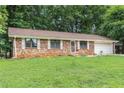 Inviting single-story brick home with a lush green lawn at 2954 Ann Marie Ln, Rex, GA 30273