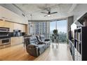 Cozy living room featuring a large window with city views, hardwood floors, and modern furnishings at 361 17Th Nw St # 2315, Atlanta, GA 30363