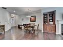 Spacious dining room featuring hardwood floors, a built-in, and natural light at 5870 Shiloh Woods Dr, Cumming, GA 30040