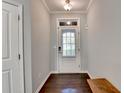 View of the foyer with dark hardwood floors, a transom window, and neutral paint at 5870 Shiloh Woods Dr, Cumming, GA 30040
