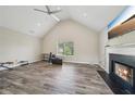 Spacious living room with vaulted ceiling, fireplace, and large window at 7169 Sweet Gum Ct, Lithonia, GA 30058