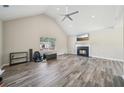 Spacious living room with vaulted ceiling, fireplace, and large window at 7169 Sweet Gum Ct, Lithonia, GA 30058