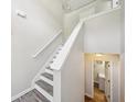Bright staircase featuring neutral walls, modern railing, and access to the upper level at 7169 Sweet Gum Ct, Lithonia, GA 30058