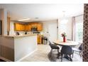 Eat-in kitchen features wood cabinets, stainless steel appliances, tile flooring, and a breakfast nook at 1020 Travitine Trl, Loganville, GA 30052