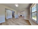 Bright living room with wood flooring, a fireplace, and natural light through a large window at 10961 Big Sky Dr, Hampton, GA 30228