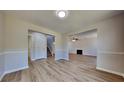 Spacious living room featuring wood flooring and a decorative fireplace at 10961 Big Sky Dr, Hampton, GA 30228