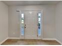 Bright entryway featuring white front door with sidelights and wood-look flooring at 2352 Benson Rdg, Lithonia, GA 30058