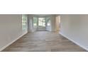 Spacious living room with lots of light, and beautiful wood-look floors at 2352 Benson Rdg, Lithonia, GA 30058