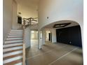 Spacious foyer featuring a grand staircase, arched doorways, and soaring ceilings for an open, airy feel at 3066 Reserve Sw Ct, Conyers, GA 30094