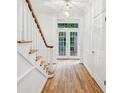 Elegant foyer with hardwood floors, staircase, and double doors leading outside, filling the space with natural light at 68 Willow Ne Gln, Atlanta, GA 30342