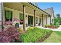 Inviting front porch with manicured landscaping, providing a warm welcome to this beautiful home at 131 Forsyth Park Ln, Woodstock, GA 30188