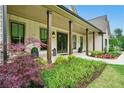 Charming front porch and beautifully landscaped walkway leading to the front door at 131 Forsyth Park Ln, Woodstock, GA 30188
