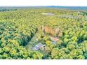 Beautiful aerial view showcases an idyllic property with a charming house, horse paddock, and lush greenery all around at 2203 Arbor Hill Rd, Canton, GA 30115