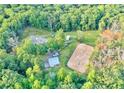 A private estate featuring a custom-built home with an horse-riding area surrounded by mature trees at 2203 Arbor Hill Rd, Canton, GA 30115