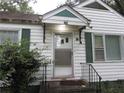 Close-up of the front door with green trim and a small porch with iron handrails at 244 Hilltop Sw Dr, Atlanta, GA 30315