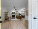 Open-concept living room with wood floors, fireplace, and views into the dining room at 245 Scotch Pine Ct, Alpharetta, GA 30022