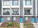 Attractive townhome showcasing a brick exterior, charming balconies, and vibrant, inviting blue doors at 701 Pryor Sw St # 5, Atlanta, GA 30315