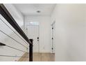 Bright hallway featuring light hardwood floors and white walls with a view of the entry door at 701 Pryor Sw St # 5, Atlanta, GA 30315