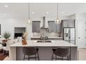 Contemporary kitchen with stainless steel appliances, gray cabinets, tile backsplash, and island at 701 Pryor Sw St # 5, Atlanta, GA 30315