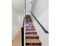 Unique stairway features decorative floral graphics on the risers and a modern black handrail at 701 Pryor Sw St # 5, Atlanta, GA 30315