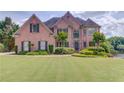 Charming two-story brick home with manicured lawn and beautiful landscaping at 1608 Mulberry Lake Dr, Dacula, GA 30019